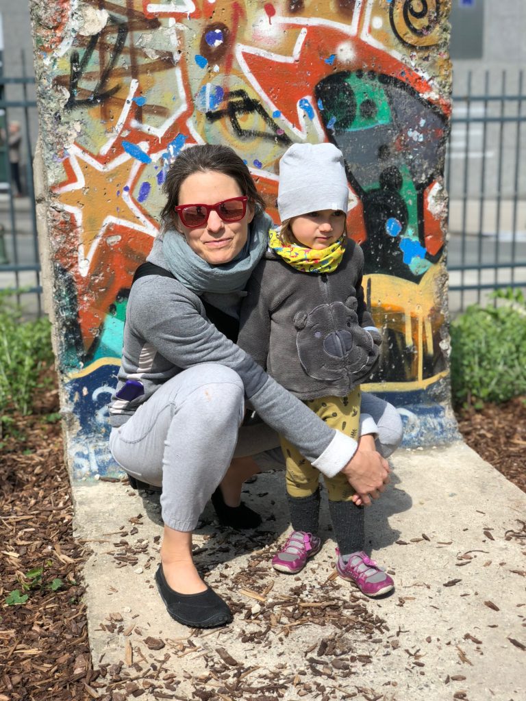 A picture of Maťka and Elisa at a piece of the Berlin wall in Brussels.